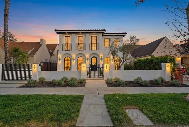 a front view of house with a garden