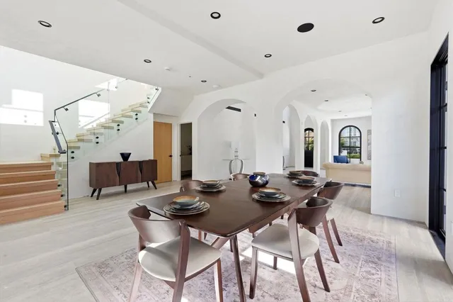 a view of a dining room with furniture and a chandelier