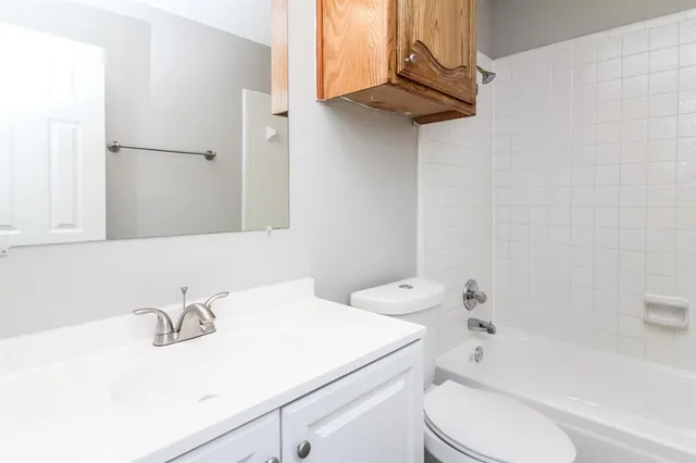 a bathroom with a sink a toilet and bathtub