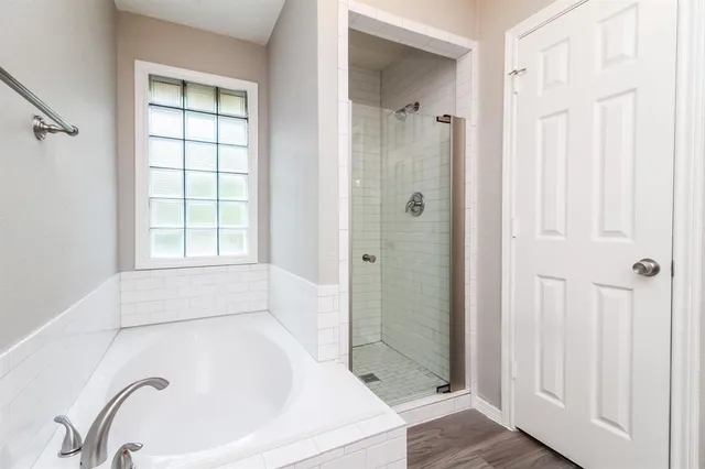 a bathroom with a bathtub and shower