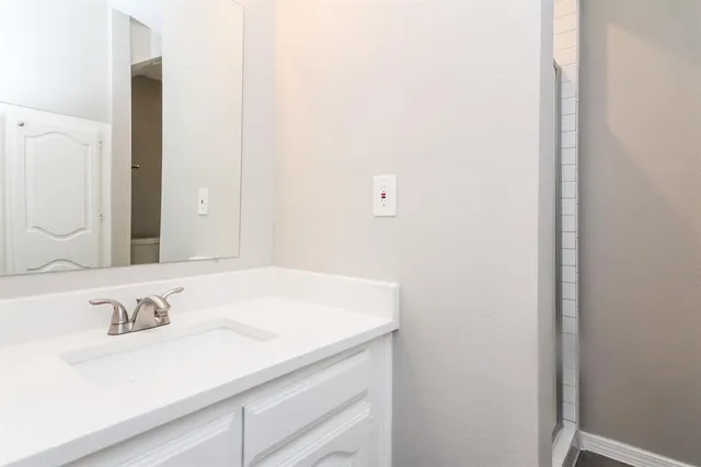 a bathroom with a sink and a mirror
