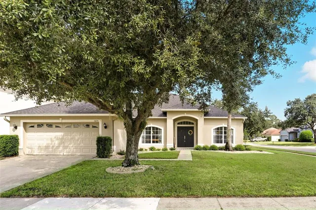 a front view of a house with a garden and yard