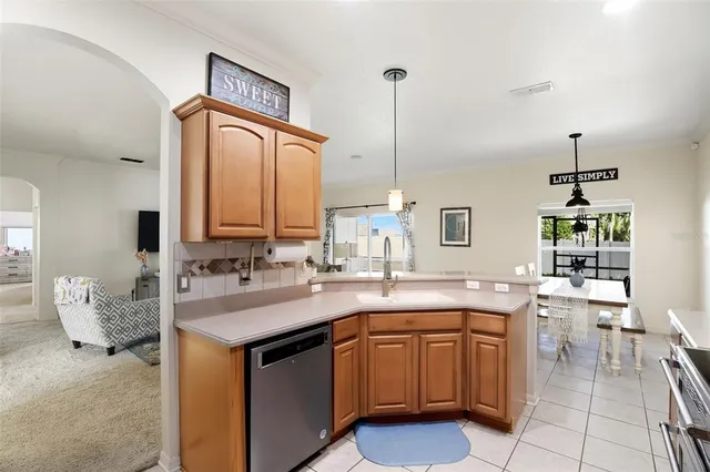 a kitchen with a sink and chairs