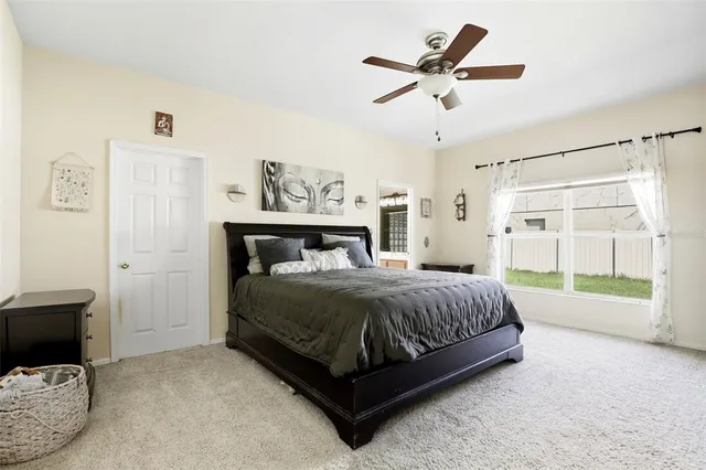 a spacious bedroom with a bed and a window