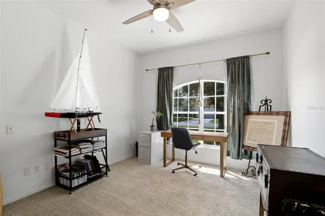 a view of a workspace with furniture and a window