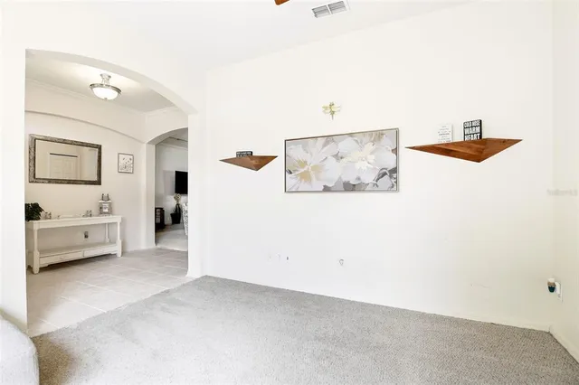 a view of a bedroom with furniture and window