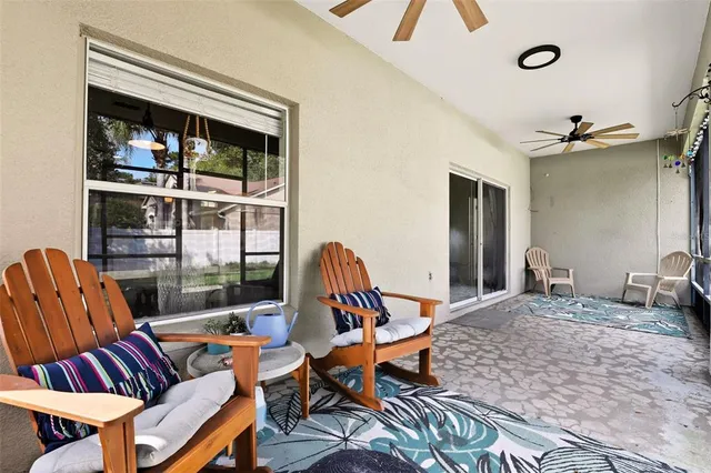 a living room with furniture a rug and a window