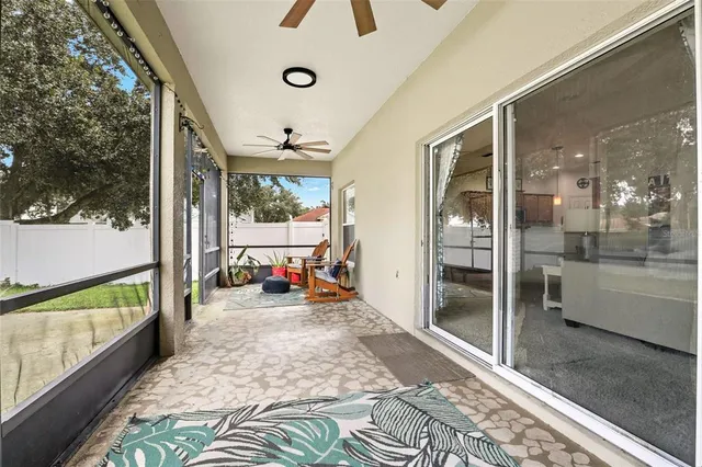 a view of a livingroom with furniture and a floor to ceiling window