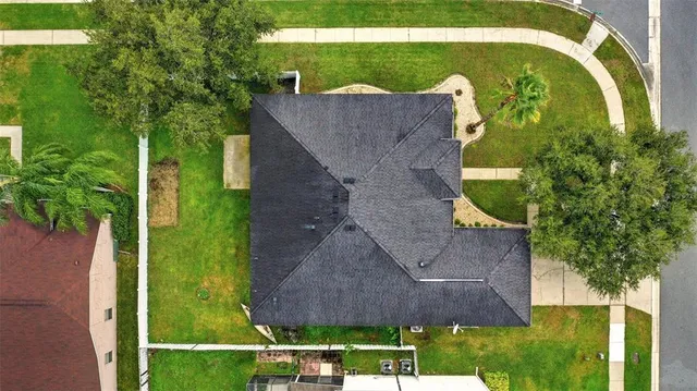 an aerial view of a house with a yard