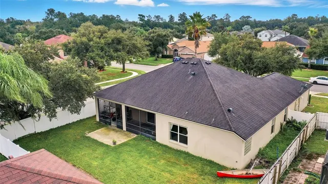 an aerial view of a house with a yard