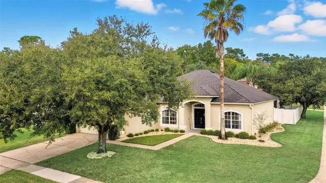 a aerial view of a house with a yard table and chairs
