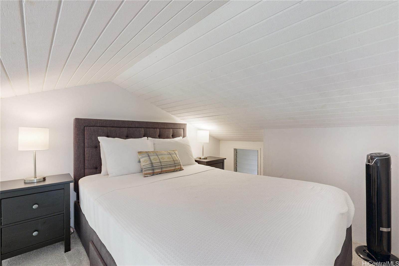 57-101 Kuilima Drive, Unit 132F Kahuku, HI 96731 - Photo 12 of 25 a bedroom with a bed and a tv