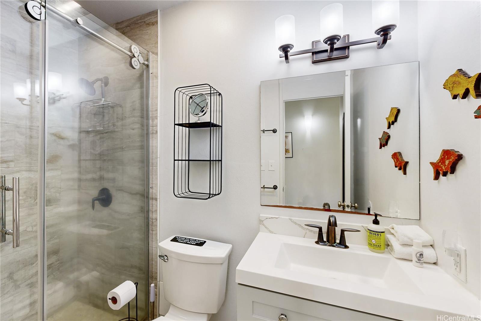 57-101 Kuilima Drive, Unit 132F Kahuku, HI 96731 - Photo 14 of 25 a bathroom with a sink toilet and shower