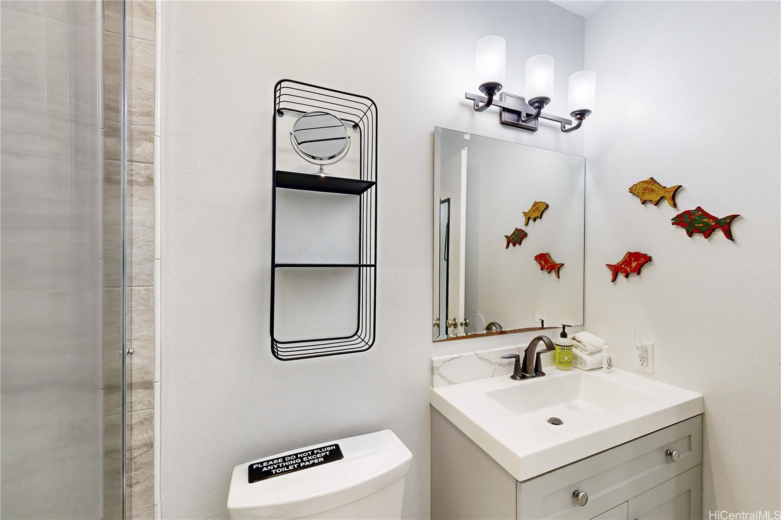 57-101 Kuilima Drive, Unit 132F Kahuku, HI 96731 - Photo 15 of 25 a bathroom with a sink mirror and vanity