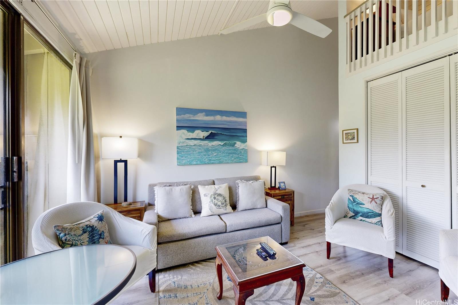 57-101 Kuilima Drive, Unit 132F Kahuku, HI 96731 - Photo 2 of 25 a living room with furniture and wooden floor