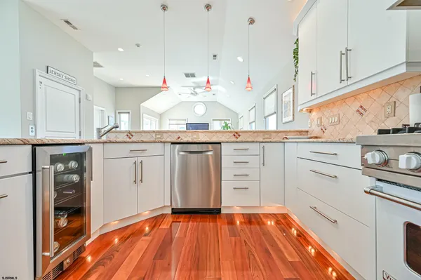 a kitchen with granite countertop white cabinets and white appliances