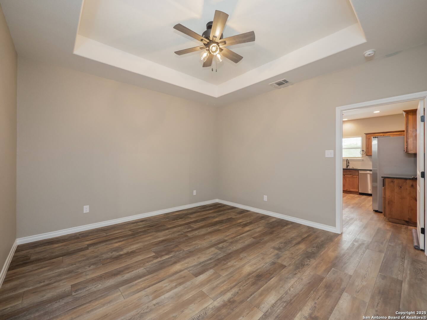 182 Inwood Poteet, TX 78065 - Photo 12 of 45 wooden floor in an empty room with a window