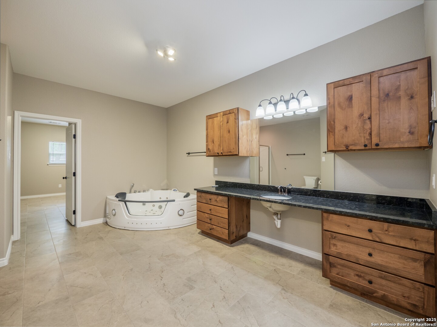 182 Inwood Poteet, TX 78065 - Photo 13 of 45 a spacious bathroom with a double vanity sink and a mirror