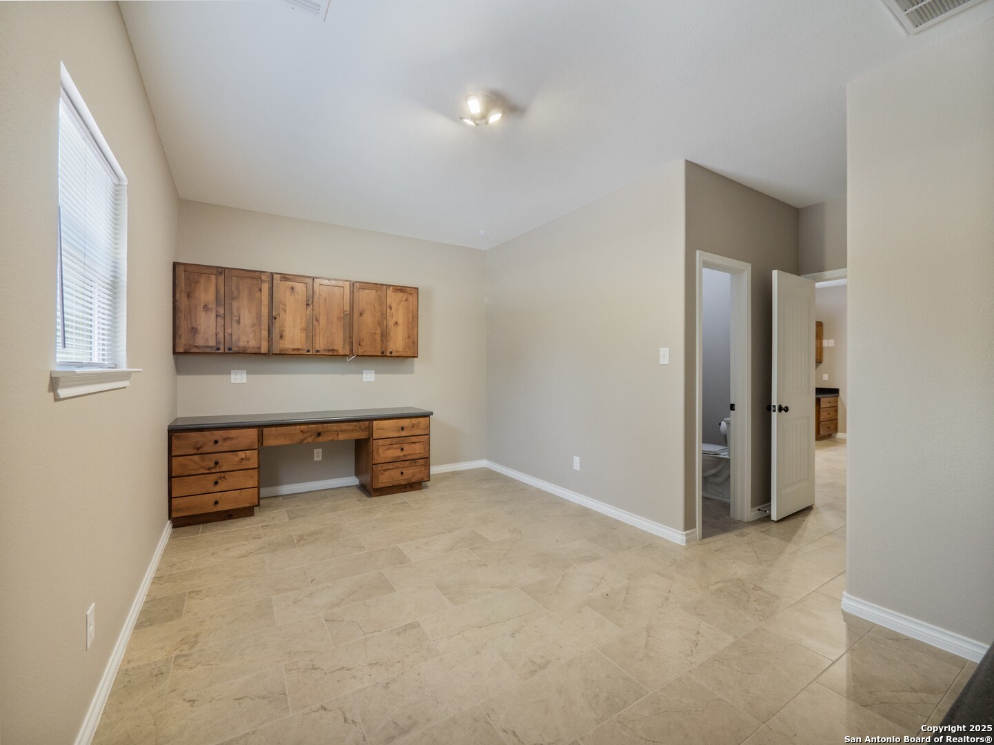182 Inwood Poteet, TX 78065 - Photo 16 of 45 an empty room with a workbench and window