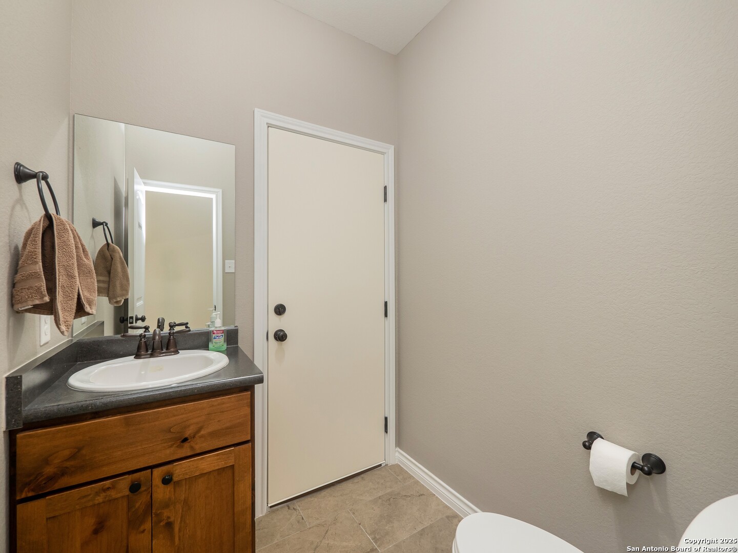 182 Inwood Poteet, TX 78065 - Photo 17 of 45 a bathroom with a sink vanity and a mirror