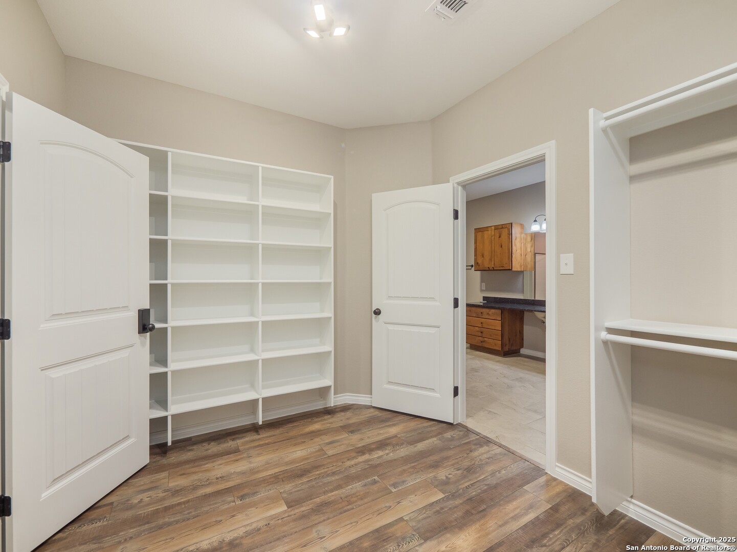 182 Inwood Poteet, TX 78065 - Photo 19 of 45 a view of a room with wooden floor and closet