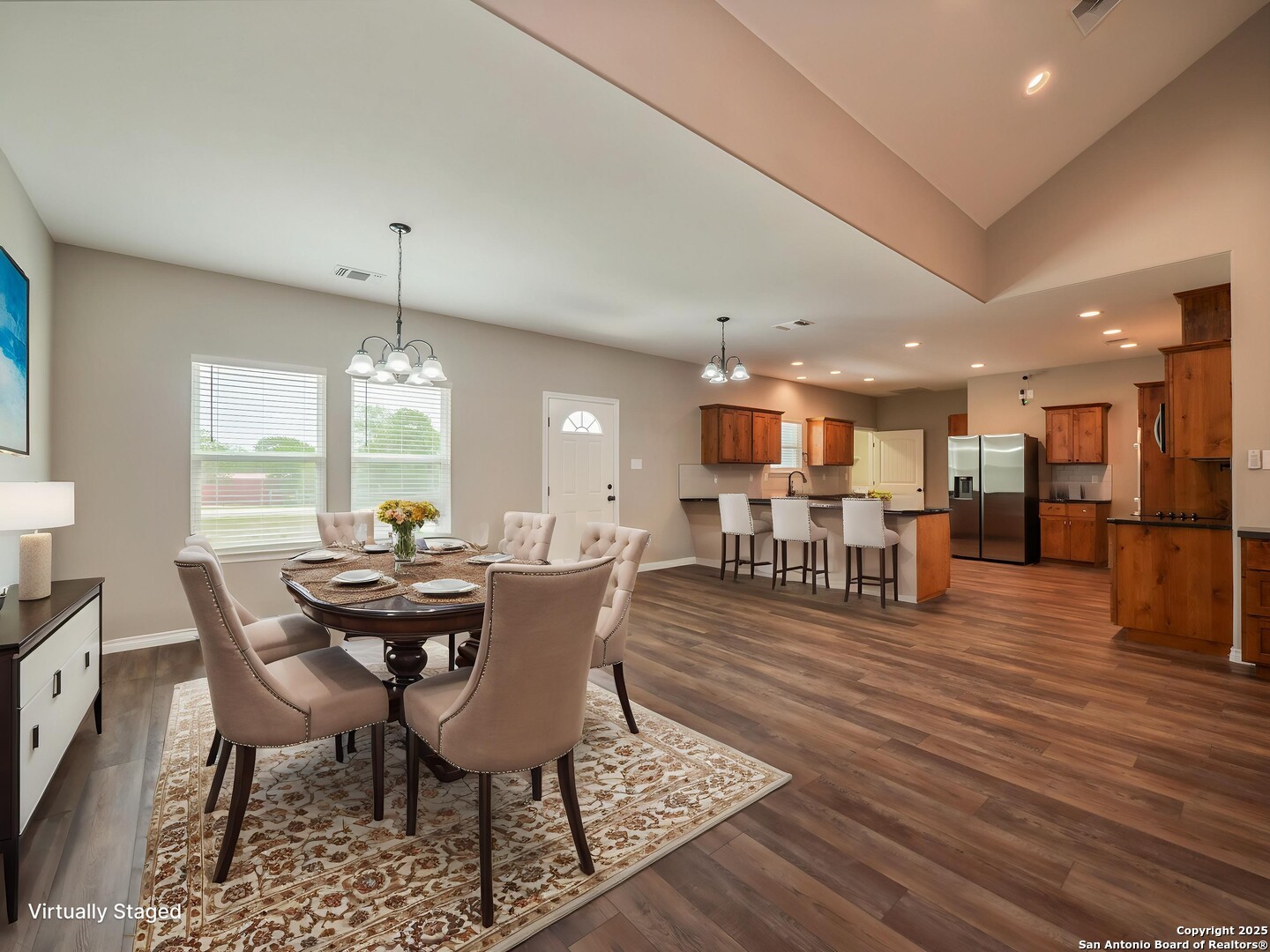182 Inwood Poteet, TX 78065 - Photo 2 of 45 a dining room with furniture a chandelier and wooden floor