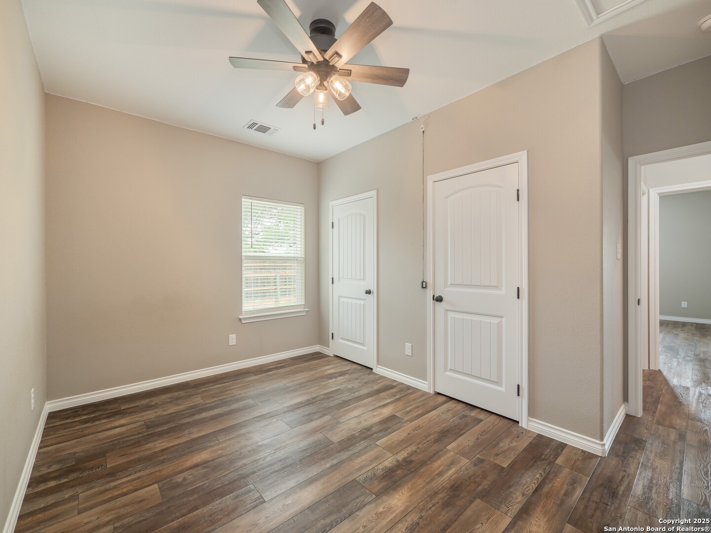 182 Inwood Poteet, TX 78065 - Photo 23 of 45 a view of an empty room with wooden floor