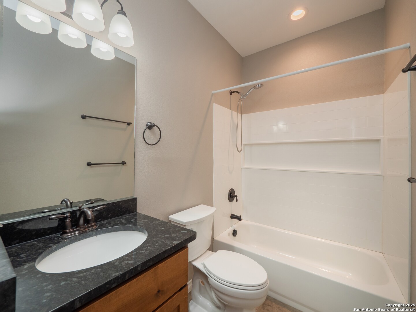 182 Inwood Poteet, TX 78065 - Photo 24 of 45 a bathroom with a granite countertop sink toilet a mirror and shower