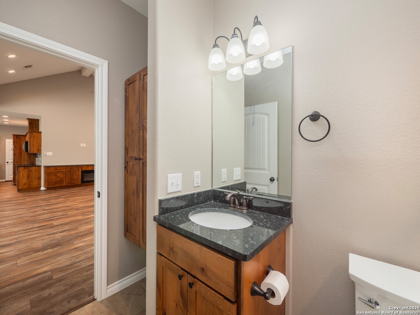 182 Inwood Poteet, TX 78065 - Photo 25 of 45 a bathroom with a sink vanity and a mirror