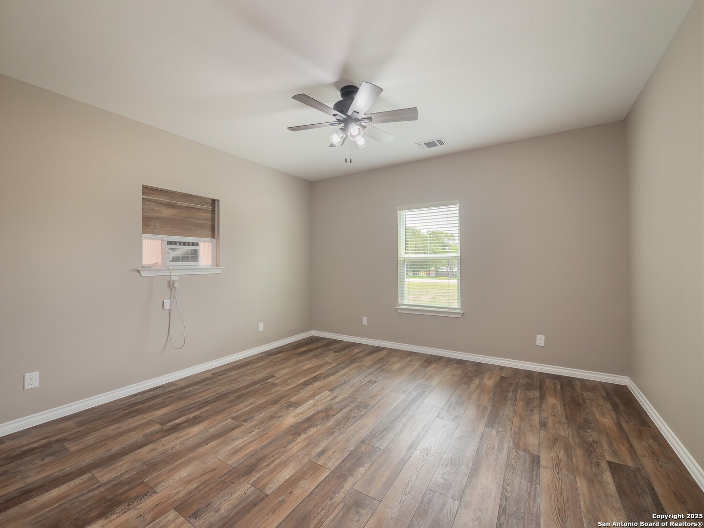 182 Inwood Poteet, TX 78065 - Photo 27 of 45 wooden floor in an empty room with a window