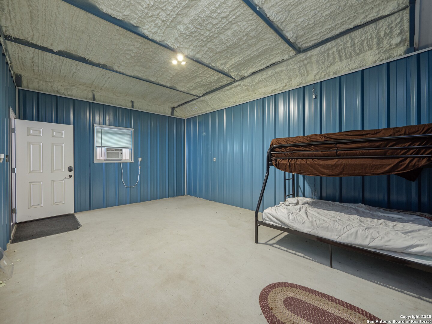 182 Inwood Poteet, TX 78065 - Photo 34 of 45 a bedroom with a bed and wooden floor