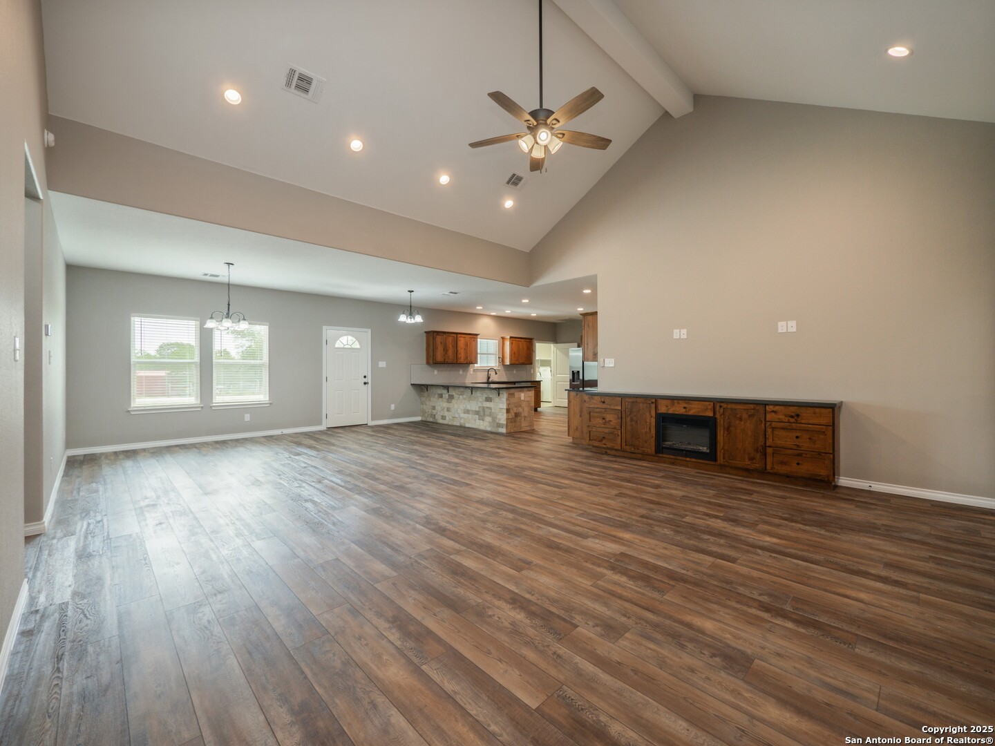 182 Inwood Poteet, TX 78065 - Photo 5 of 45 a view of an empty room with a window and wooden floor