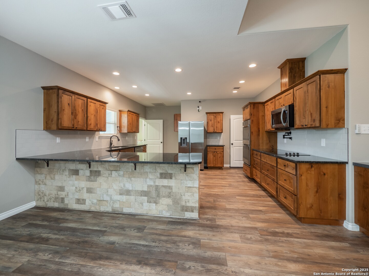 182 Inwood Poteet, TX 78065 - Photo 6 of 45 a large kitchen with stainless steel appliances lots of counter space and a sink