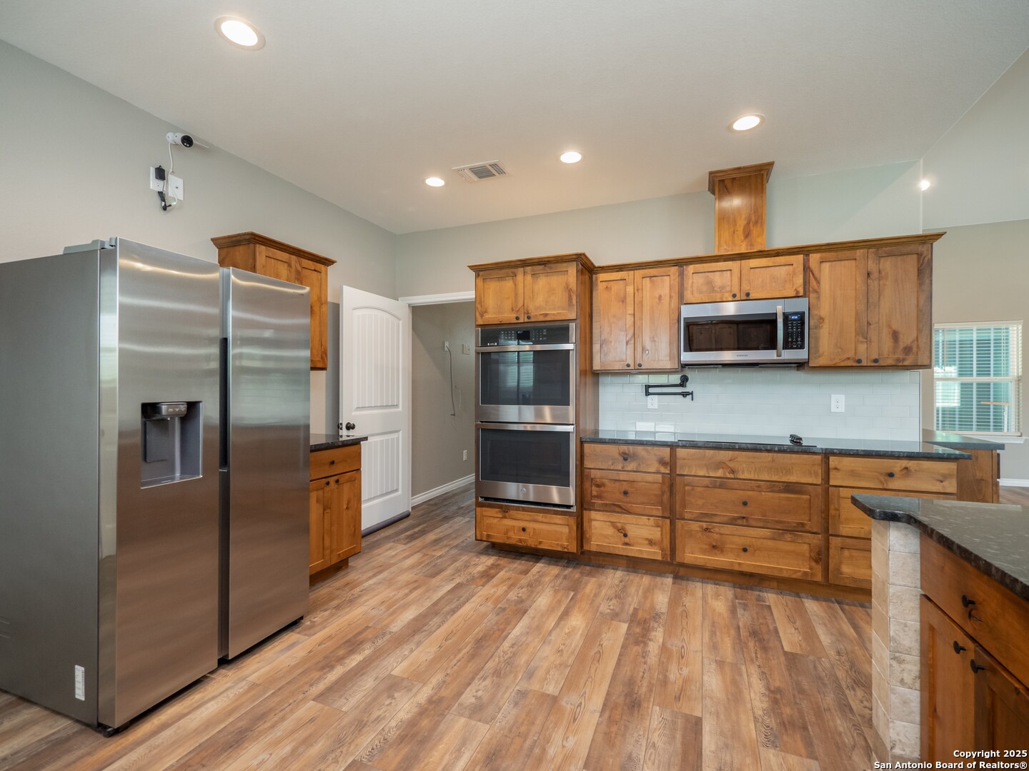 182 Inwood Poteet, TX 78065 - Photo 7 of 45 a kitchen with stainless steel appliances a refrigerator and a stove top oven