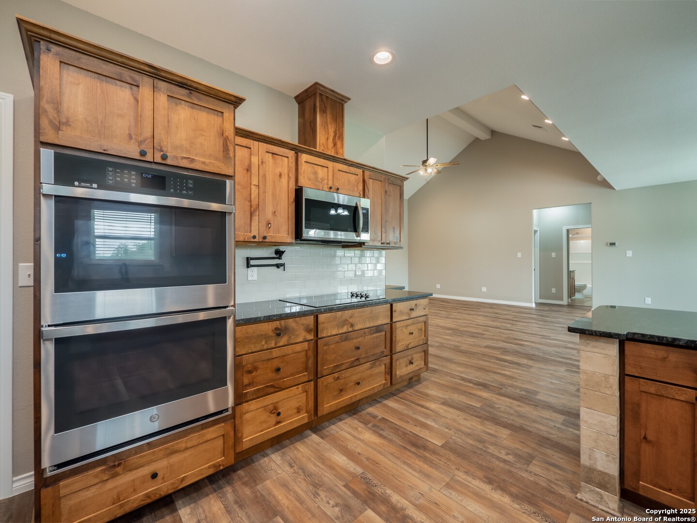 182 Inwood Poteet, TX 78065 - Photo 9 of 45 a kitchen with stainless steel appliances kitchen island granite countertop a stove microwave and refrigerator