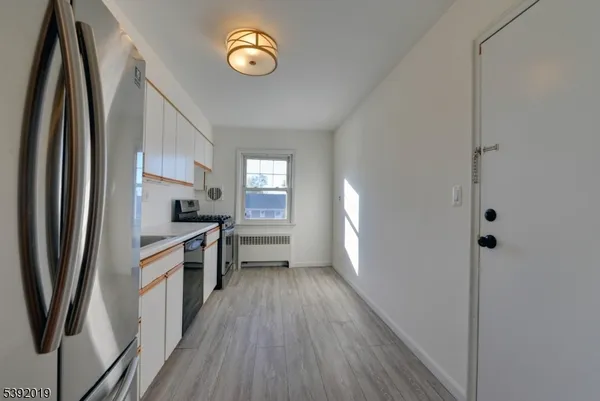 a kitchen with stainless steel appliances a refrigerator sink and stove