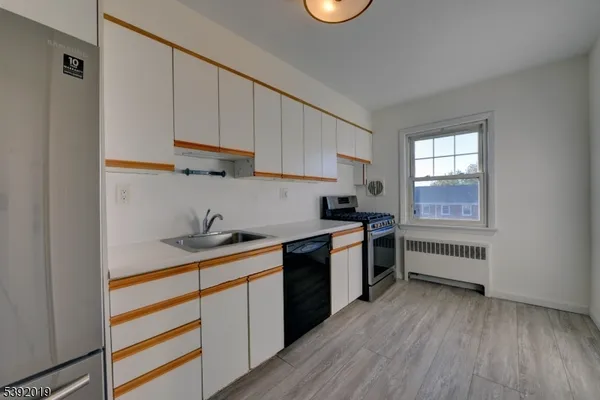 a kitchen with a sink a stove and cabinets