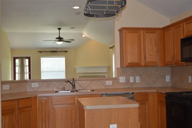 a kitchen with stainless steel appliances a stove sink and microwave