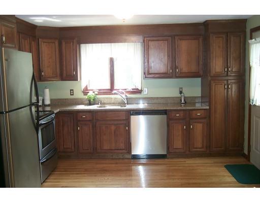 446 Spring Street Hanson, MA 02341 - Photo 2 of 12 a kitchen with stainless steel appliances granite countertop a sink stove and refrigerator