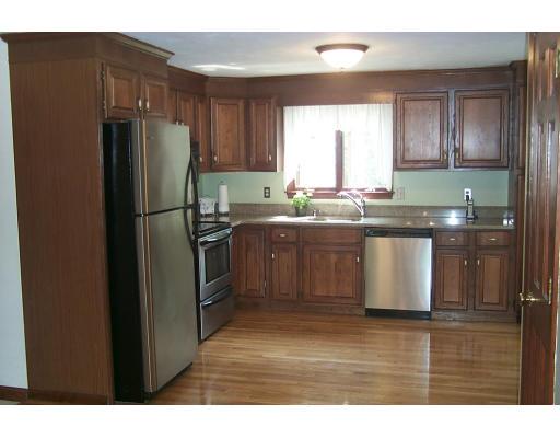 446 Spring Street Hanson, MA 02341 - Photo 3 of 12 a kitchen with stainless steel appliances granite countertop a refrigerator a sink a stove a microwave and island