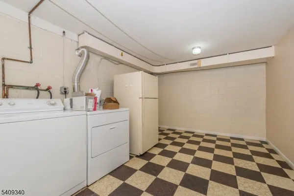 a kitchen with a checkered floor and white cabinets
