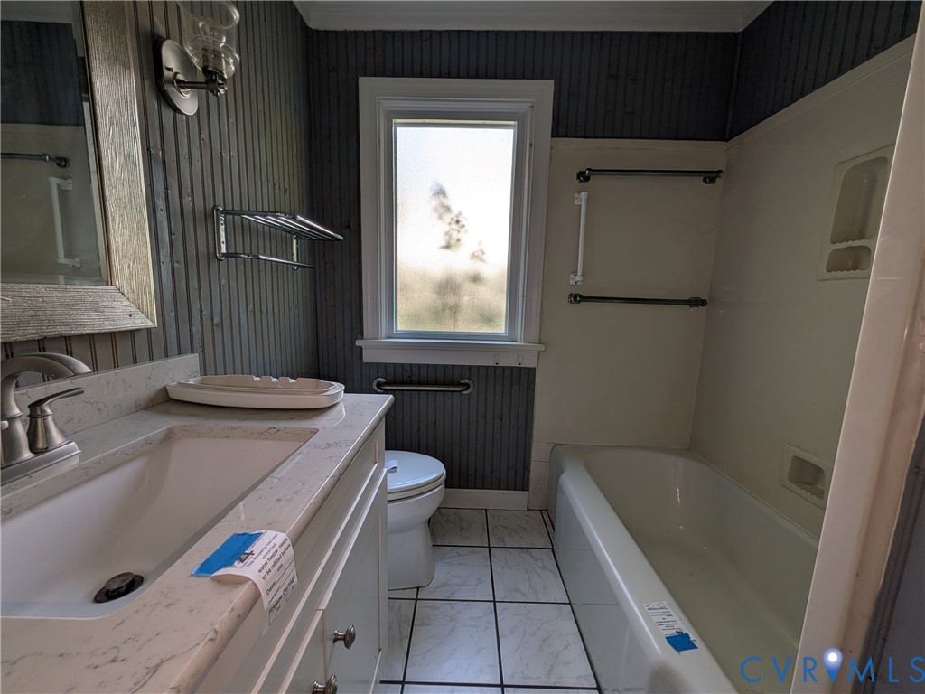 12307 Buckingham Street Chester, VA 23831 - Photo 23 of 40 a bathroom with a sink a toilet and tub
