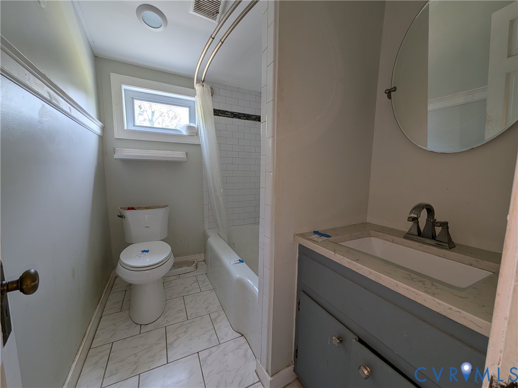 12307 Buckingham Street Chester, VA 23831 - Photo 29 of 40 a bathroom with a granite countertop toilet a sink and mirror