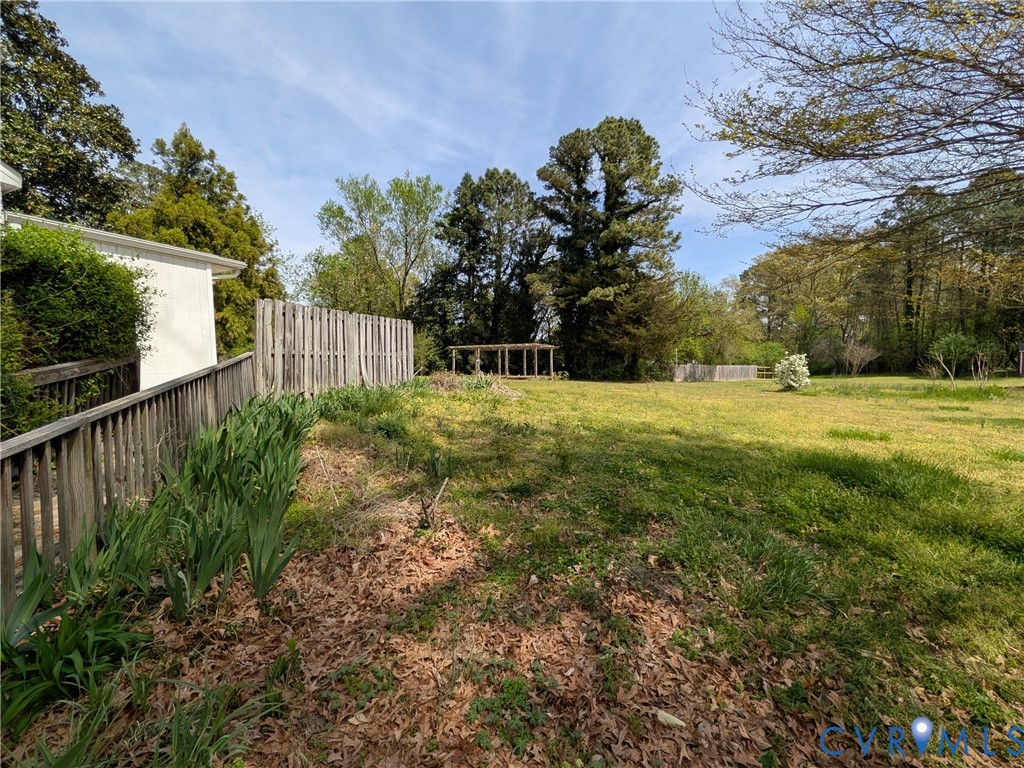 12307 Buckingham Street Chester, VA 23831 - Photo 4 of 40 a view of a big yard with wooden fence