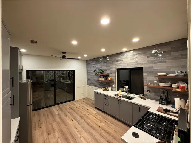 a large kitchen with a large counter top appliances and cabinets