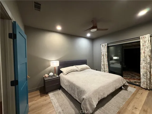 a bedroom with a large bed and a tv