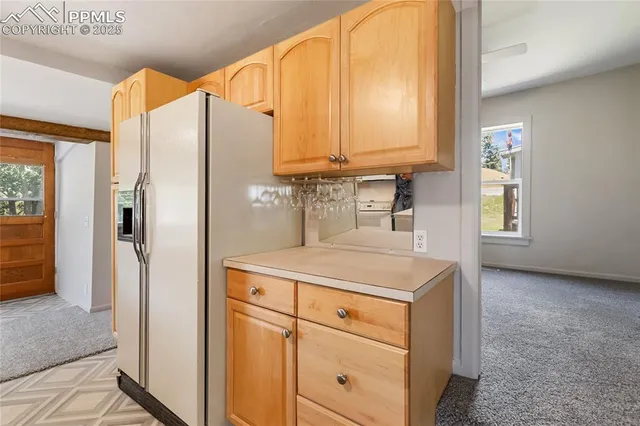a kitchen with a stove sink and cabinets