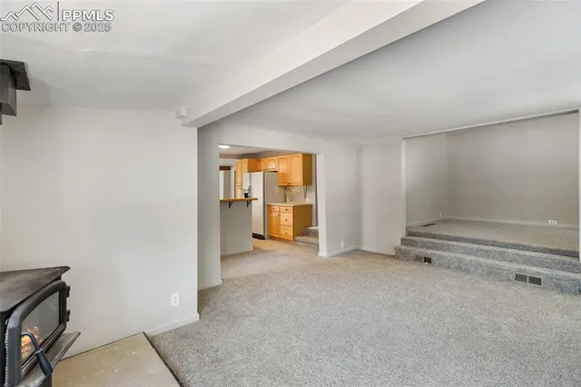 a kitchen with stainless steel appliances cabinets and a window
