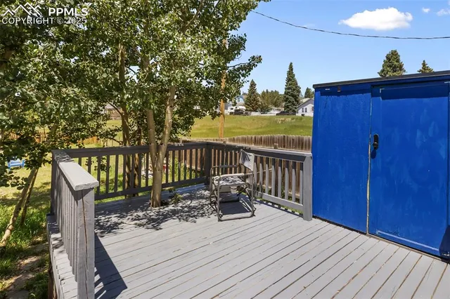 a view of a chair and table in the backyard