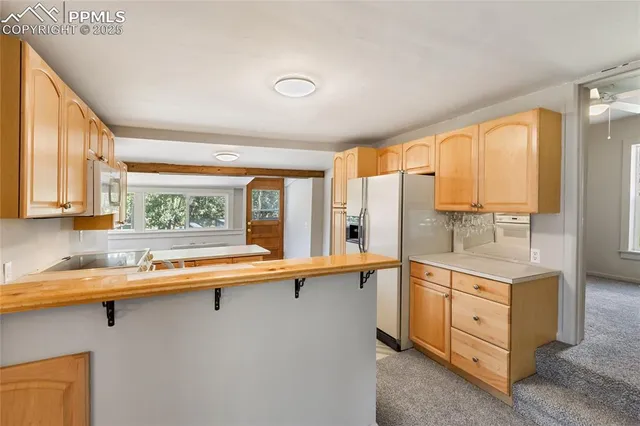 a kitchen that has a sink and a stove in it